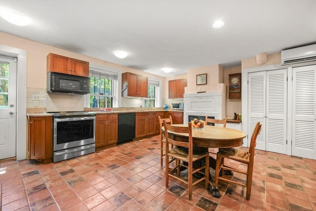 66 Rutland St, Boston, MA 02118 - kitchen with black appliances, a wall mounted AC, backsplash, light countertops, and brown cabinetry