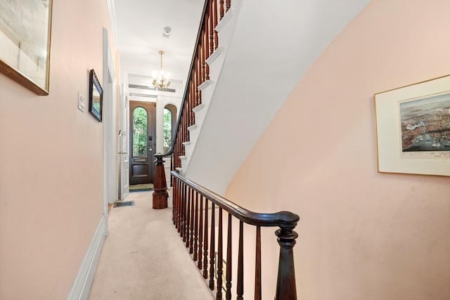 66 Rutland St, Boston, MA 02118 - hall with a chandelier, stairway, light colored carpet, and ornamental molding