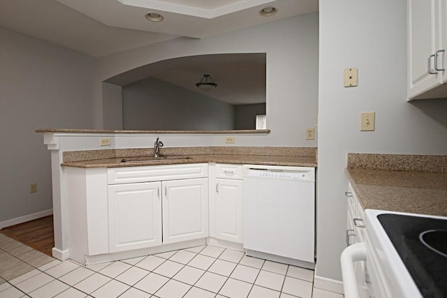 kitchen with a sink, recessed lighting, white appliances, white cabinets, and light tile patterned floors