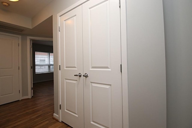 corridor with dark wood finished floors and visible vents