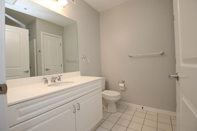 bathroom featuring baseboards, toilet, vanity, and tile patterned flooring