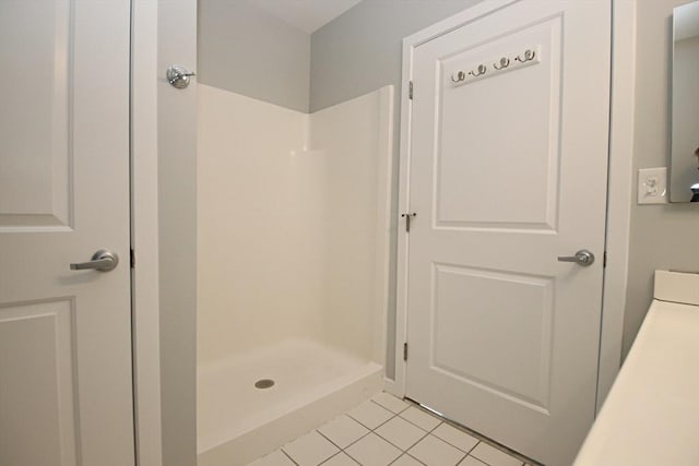 full bath featuring a shower stall and tile patterned floors