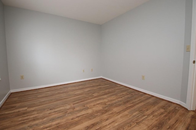 unfurnished room featuring wood finished floors and baseboards