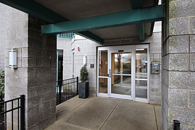 view of exterior entry featuring concrete block siding