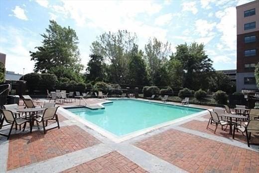 community pool featuring a patio and fence