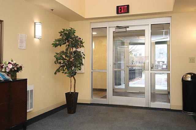 doorway with visible vents and baseboards