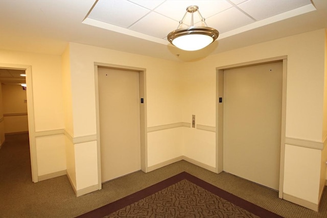 interior space featuring elevator and dark colored carpet