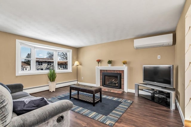 living room featuring an AC wall unit, a fireplace, baseboards, and wood finished floors