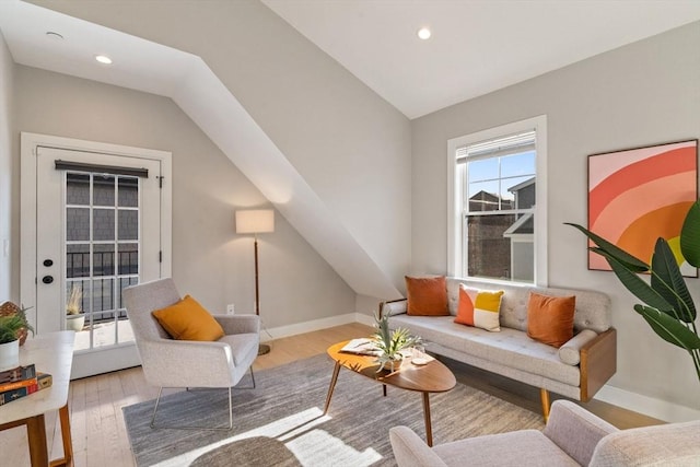 living area with vaulted ceiling, recessed lighting, light wood-type flooring, and baseboards