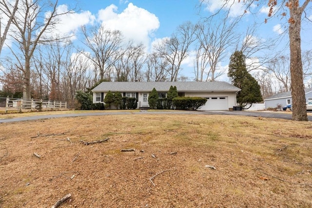 single story home with a front yard and a garage