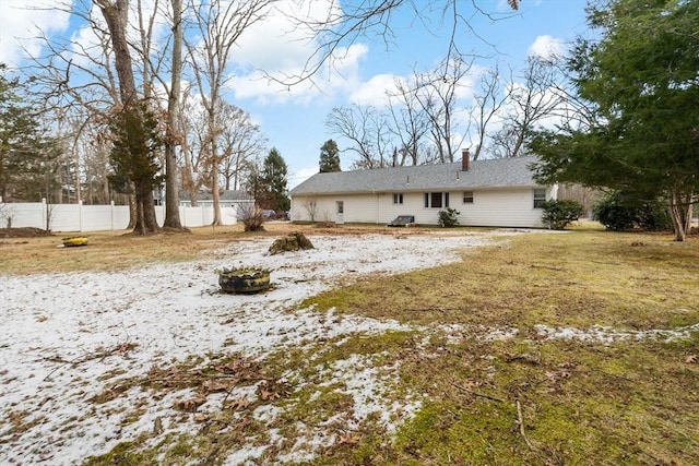 back of house featuring a lawn