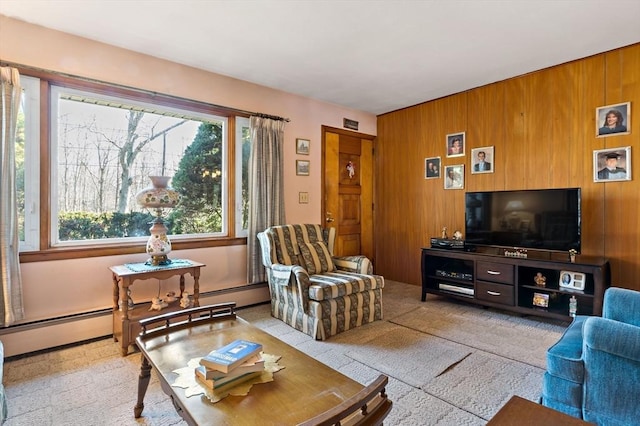 living room featuring a baseboard radiator and wood walls