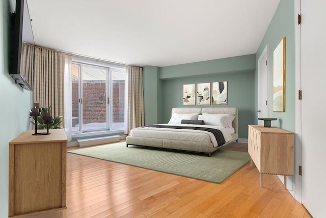 bedroom with hardwood / wood-style flooring and floor to ceiling windows