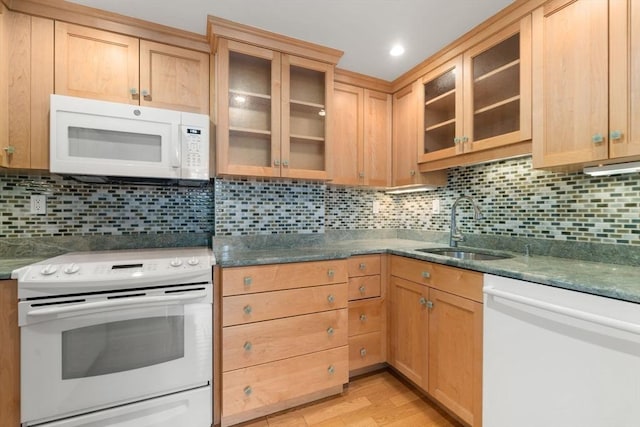 kitchen with white appliances, sink, light hardwood / wood-style flooring, and backsplash