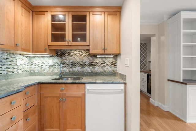 kitchen featuring sink, light hardwood / wood-style flooring, white dishwasher, tasteful backsplash, and dark stone counters