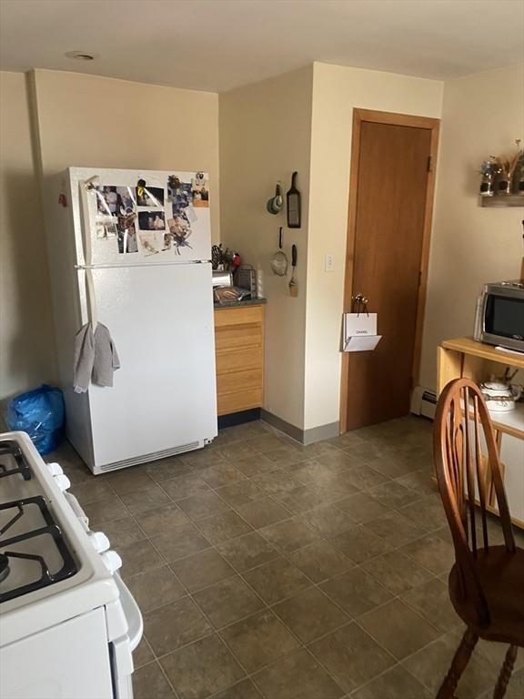 kitchen with white appliances, baseboards, and baseboard heating