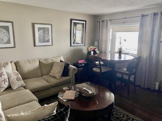 living area with a textured ceiling and wood finished floors