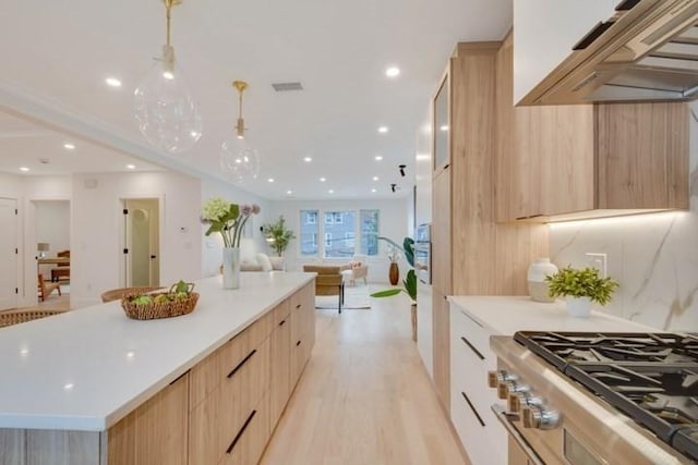 kitchen featuring light wood-style flooring, modern cabinets, open floor plan, and light brown cabinetry