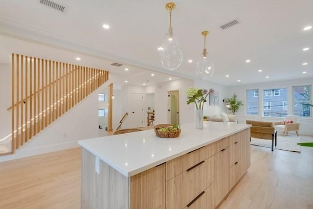 kitchen with open floor plan, modern cabinets, light brown cabinets, and visible vents