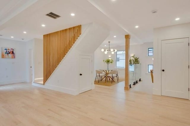 foyer featuring light wood-style flooring, decorative columns, visible vents, and recessed lighting