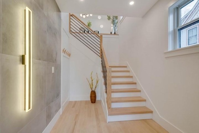 stairs featuring recessed lighting and wood finished floors