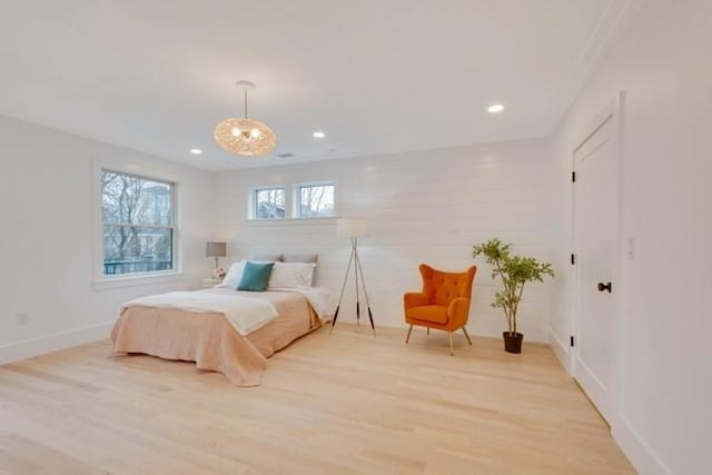 bedroom with recessed lighting, a notable chandelier, light wood-style flooring, and baseboards