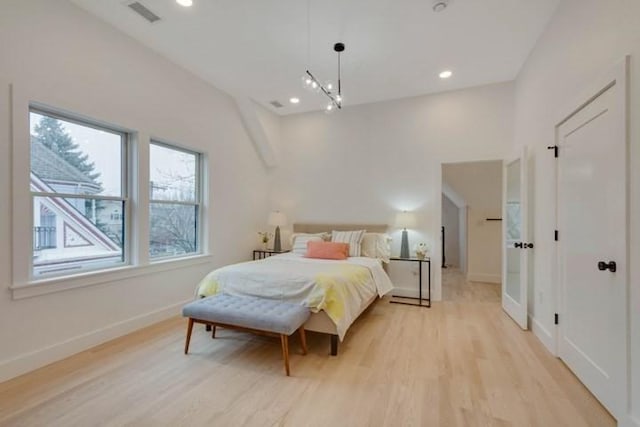 bedroom with light wood-type flooring, baseboards, visible vents, and recessed lighting