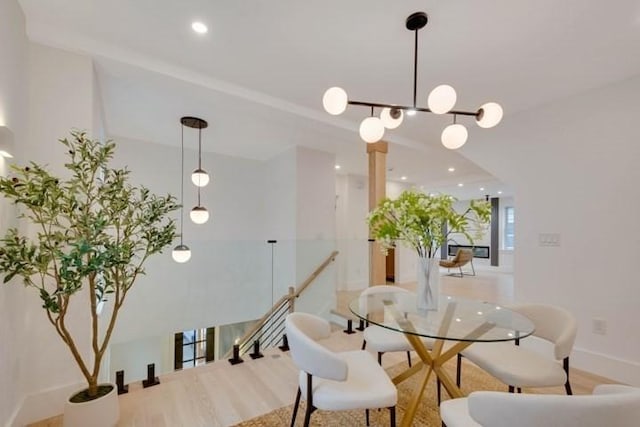 dining area featuring baseboards, wood finished floors, and recessed lighting