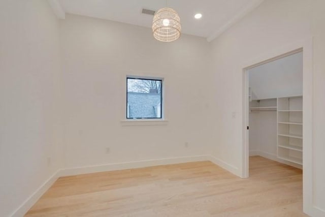 spare room featuring light wood-style floors, visible vents, baseboards, and recessed lighting