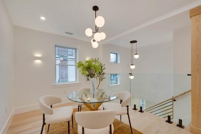 dining space featuring visible vents, baseboards, wood finished floors, and recessed lighting