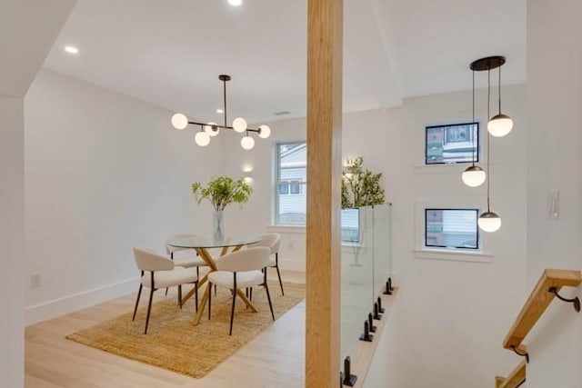 dining room featuring recessed lighting, an inviting chandelier, baseboards, and wood finished floors