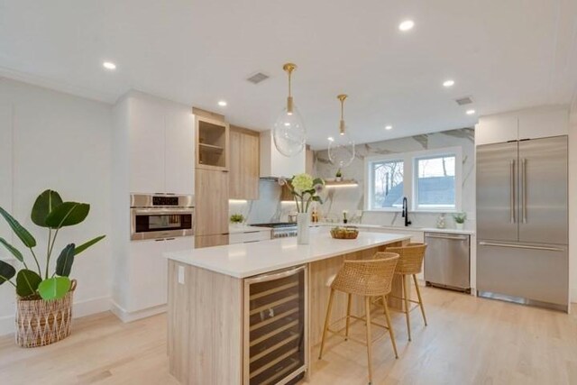 kitchen featuring beverage cooler, a kitchen island, modern cabinets, appliances with stainless steel finishes, and open shelves