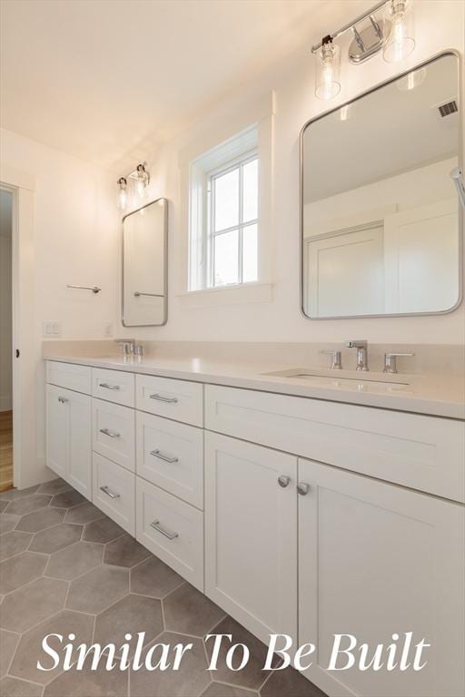 bathroom featuring double vanity, visible vents, a sink, and tile patterned flooring