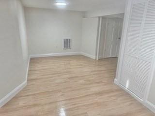 16 Fowler St, Boston, MA 02121 - empty room featuring baseboards and wood finished floors