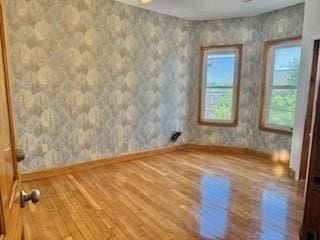 16 Fowler St, Boston, MA 02121 - spare room with wood finished floors, baseboards, and wallpapered walls