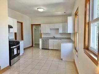 16 Fowler St, Boston, MA 02121 - kitchen featuring stainless steel range oven, dishwashing machine, white cabinets, and baseboards