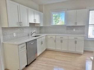16 Fowler St, Boston, MA 02121 - kitchen with dishwasher, light countertops, backsplash, and light wood-style floors
