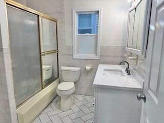 16 Fowler St, Boston, MA 02121 - full bath with vanity, toilet, combined bath / shower with glass door, and tile walls