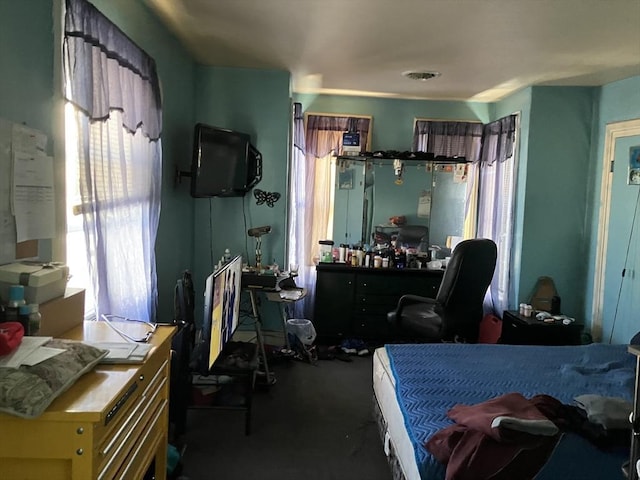 carpeted bedroom featuring multiple windows