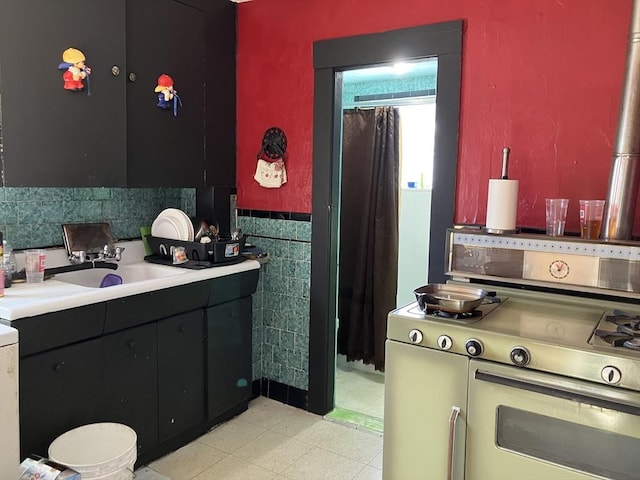 kitchen with sink, tile walls, and double oven range