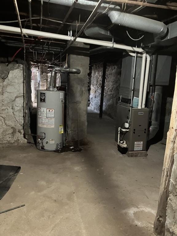 utility room featuring water heater and heating unit