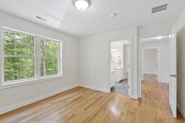 6 Beacon Ct, Acton, MA 01720 - unfurnished bedroom with light wood-style flooring, baseboards, and ensuite bath