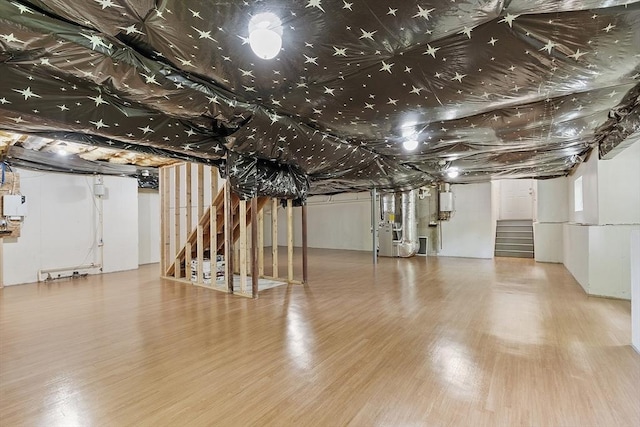 6 Beacon Ct, Acton, MA 01720 - unfinished below grade area with stairway, wood finished floors, and heating unit