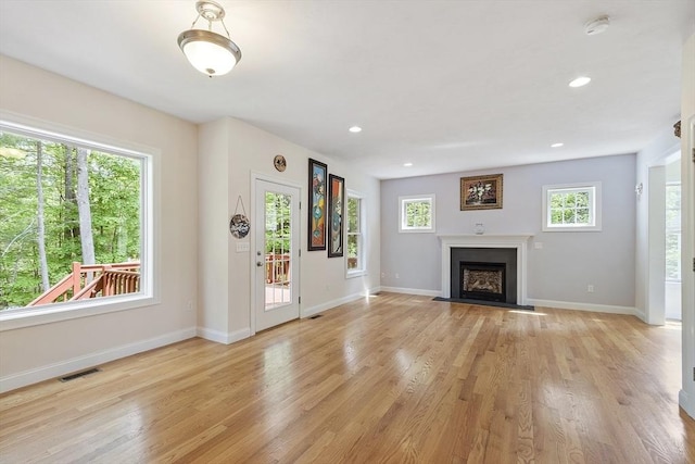 6 Beacon Ct, Acton, MA 01720 - unfurnished living room featuring light wood-type flooring, baseboards, a fireplace with flush hearth, and recessed lighting
