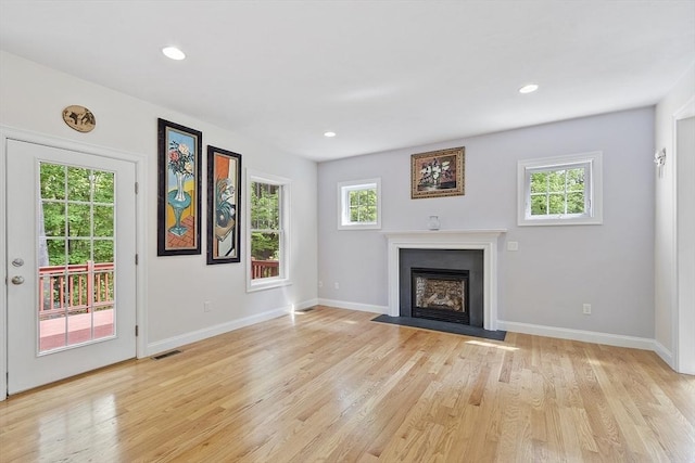 6 Beacon Ct, Acton, MA 01720 - unfurnished living room with a fireplace with flush hearth, baseboards, light wood-style flooring, and recessed lighting
