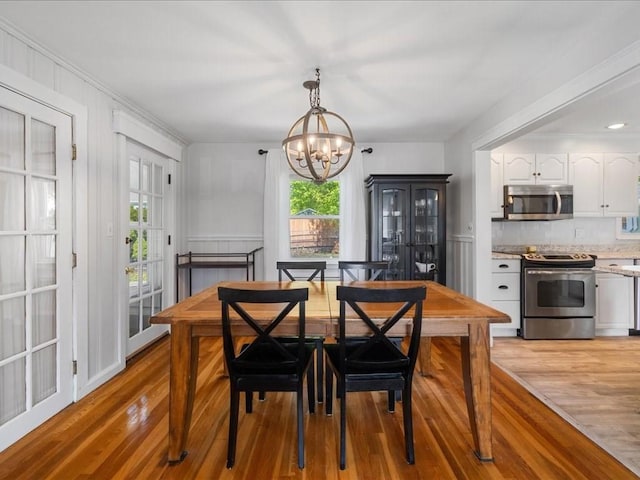 114 Hobart St, Braintree, MA 02184 - dining space featuring ornamental molding, a notable chandelier, and light wood-style floors