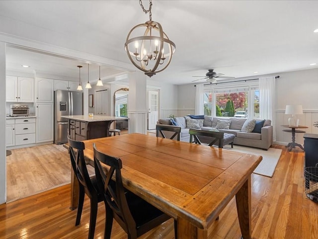 114 Hobart St, Braintree, MA 02184 - dining room featuring a wainscoted wall, light wood-style floors, a toaster, and ceiling fan with notable chandelier