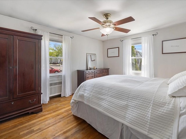 114 Hobart St, Braintree, MA 02184 - bedroom with light wood-style flooring, a ceiling fan, and radiator heating unit