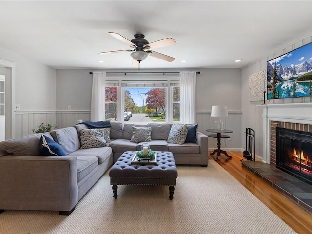 114 Hobart St, Braintree, MA 02184 - living room featuring a ceiling fan, a brick fireplace, wainscoting, and wood finished floors