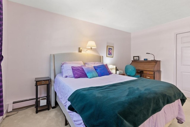 bedroom featuring carpet and a baseboard heating unit